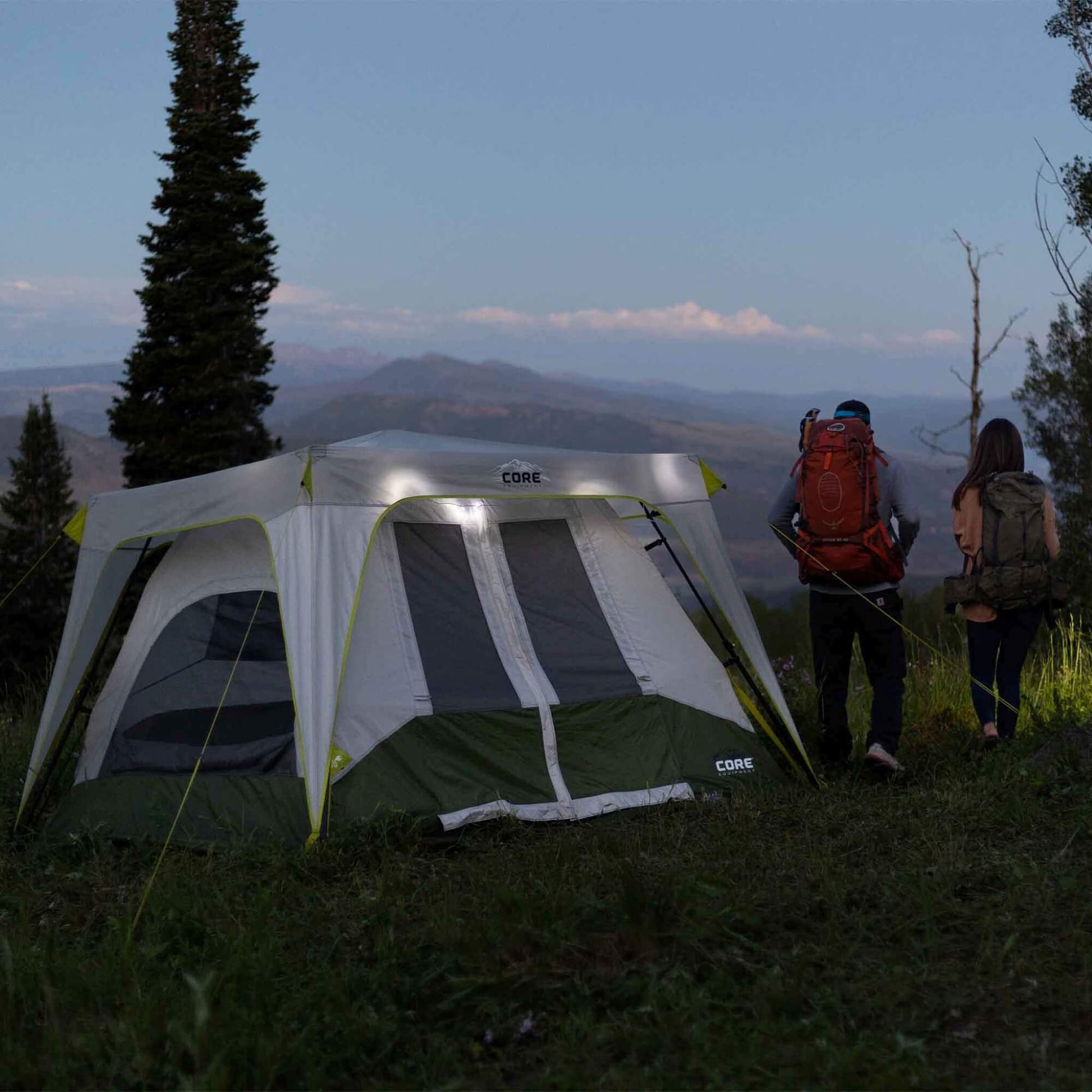 CORE camping string lights illuminating a tent at dusk, providing ambient outdoor lighting for campsite or backyard.