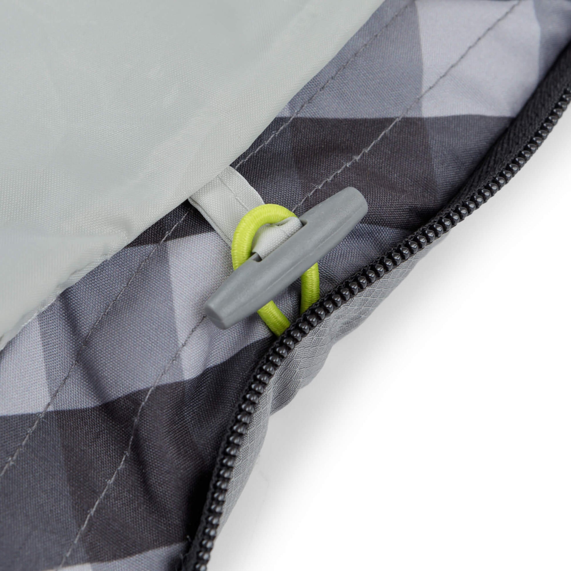 Close-up of a zipper with a gray pull tab on a CORE sleeping bag. 