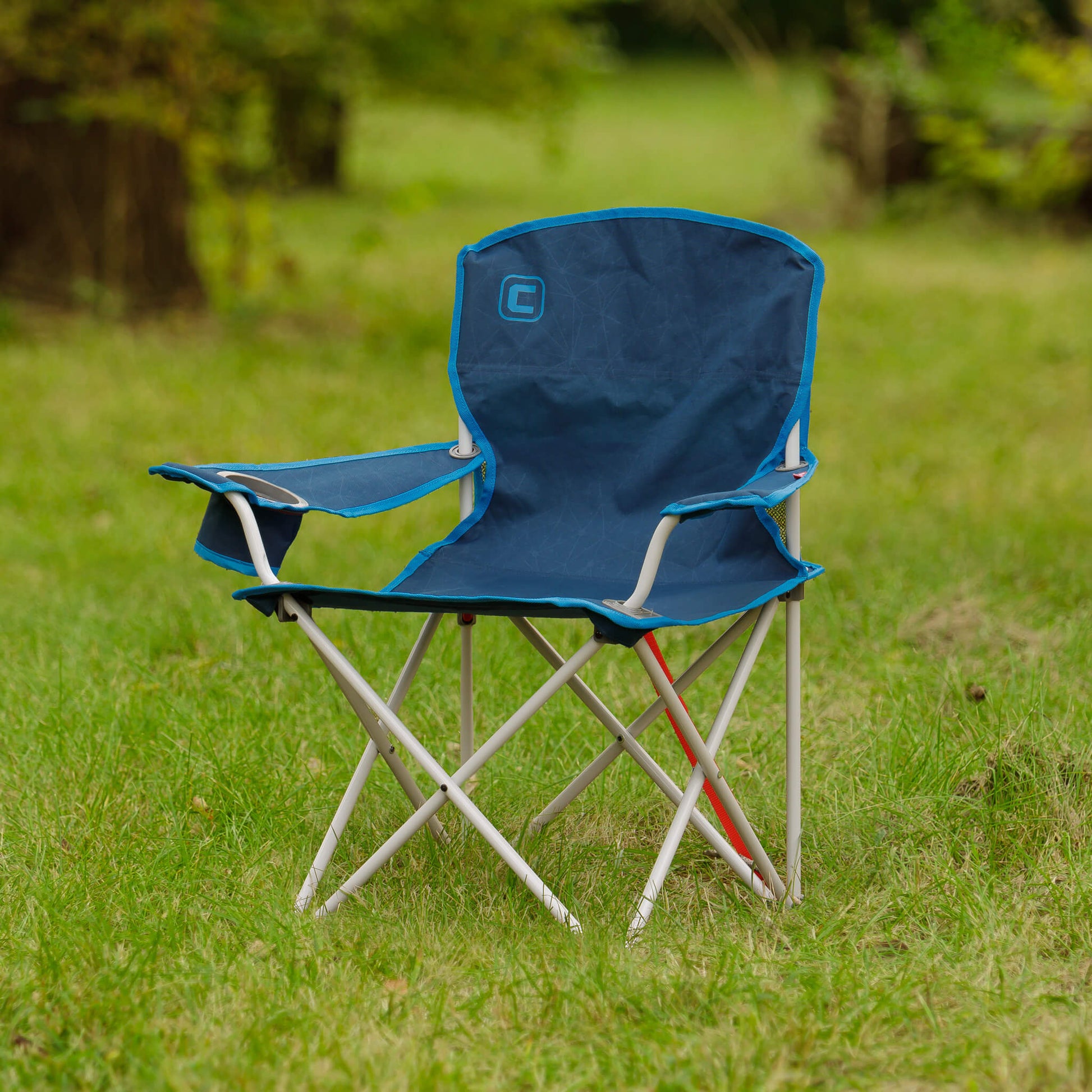 CORE youth camp chair in galaxy blue shown outdoors on grass.
