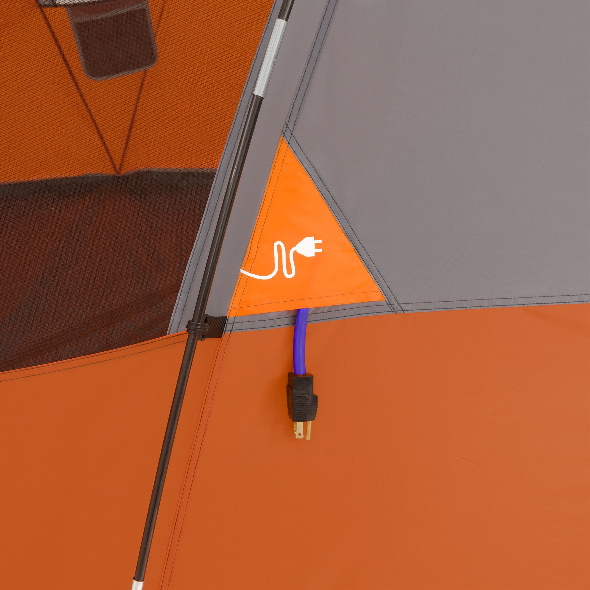 Close-up of an orange and grey tent featuring an electrical cord access flap, perfect for outdoor camping. The flap is marked with an icon of a plug, and a blue electrical cord is seen running through it. The CORE 9 Person Extended Dome Tent's black support pole is visible on the left side of the image.