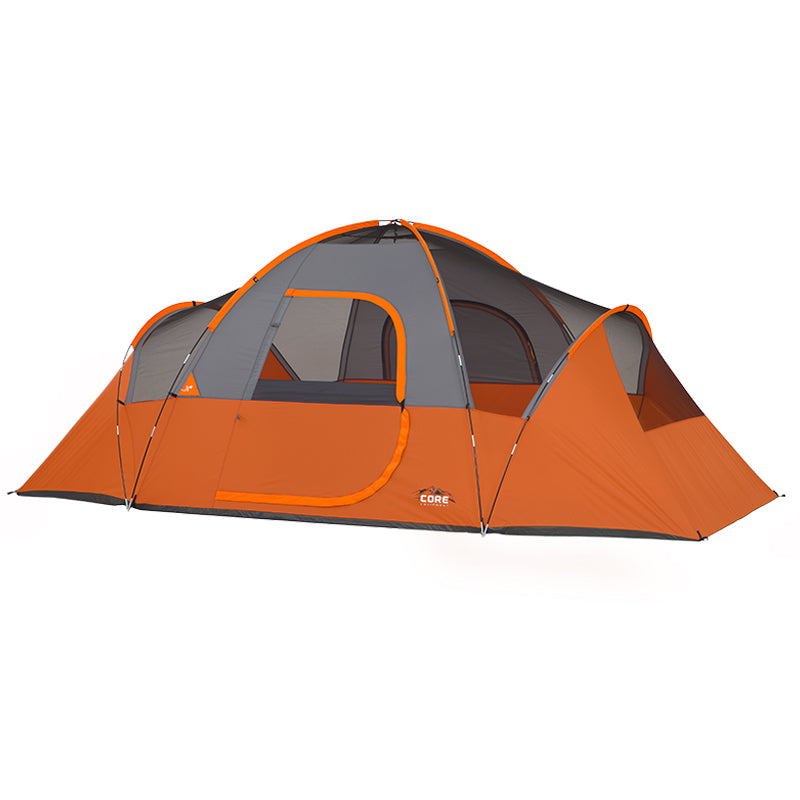 An orange and gray 9 Person Extended Dome Tent with a dome structure and multiple mesh windows. The tent is branded with the "CORE" logo and appears spacious, suitable for multiple occupants. It is pitched on a flat surface with its entryway closed.