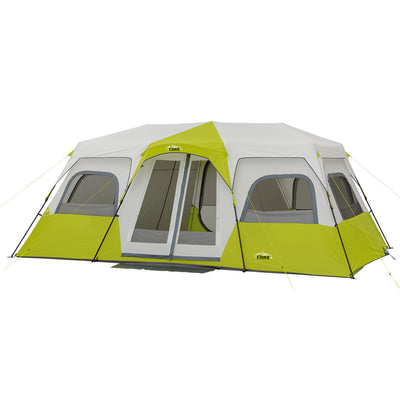 A large, two-toned green and gray tent with multiple windows and two entrances. The 12 Person Instant Cabin Tent has a peaked roof and is supported by multiple poles. The brand "CORE" is visible on the tent. The design suggests it is suitable for large groups or families.