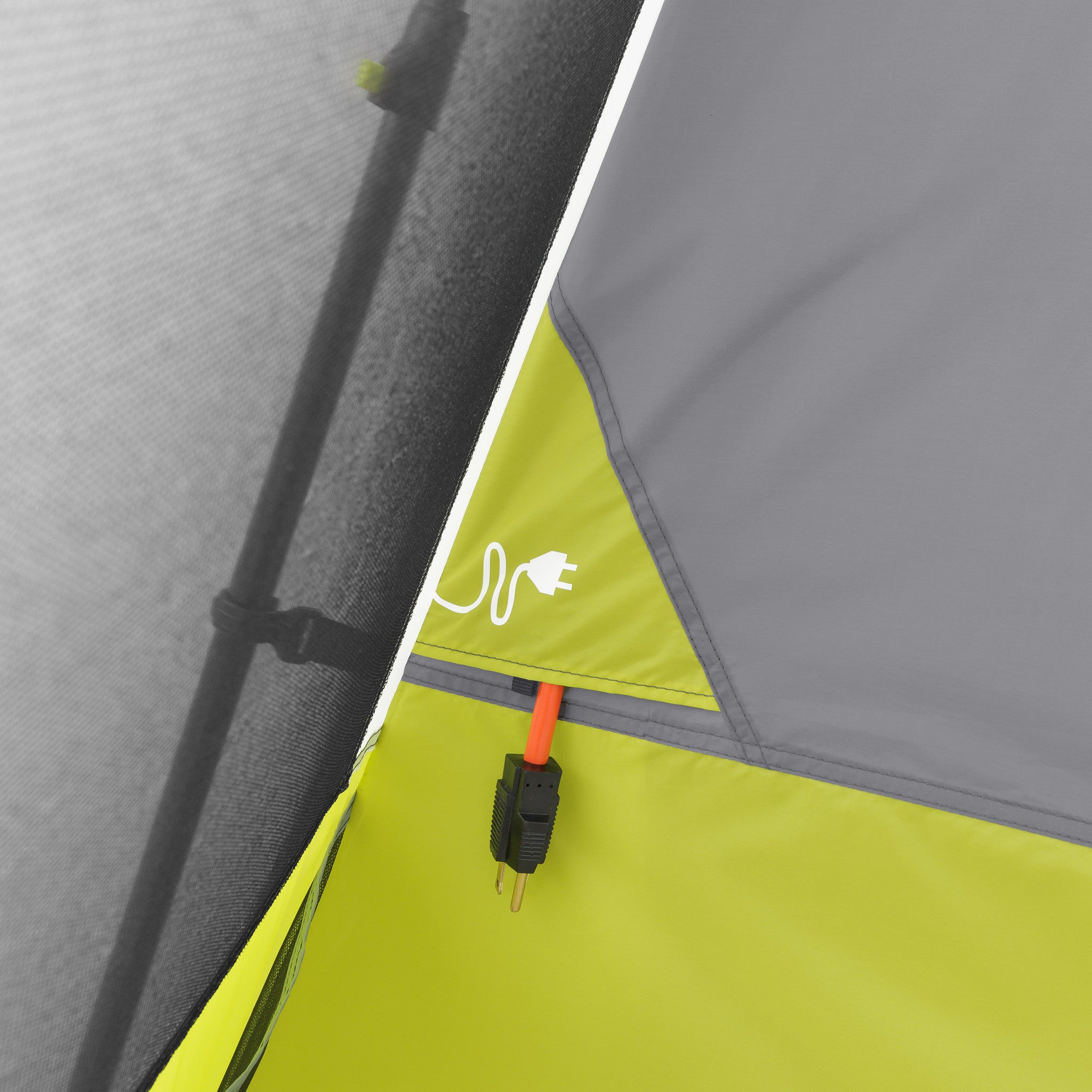 Close-up view of a tent wall with a power cord passing through a small port in the fabric. The green yellow and gray CORE 10 Person Instant Cabin Tent with Screen Room has mesh netting visible on the left side.