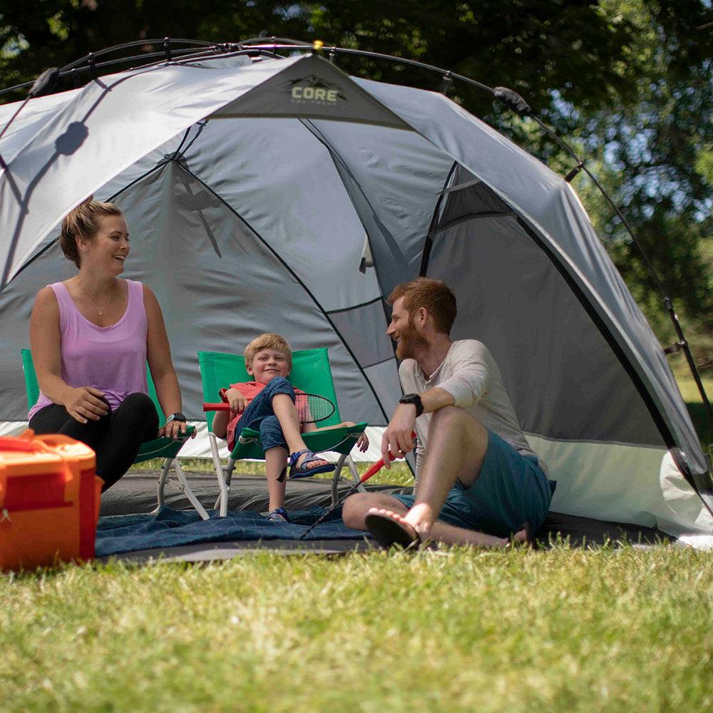 Lifestyle image of 8x8 Instant Sport Shade Dark version with family at park enjoying shade with side panels fully zipped